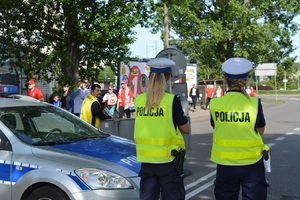 Zdjęcie poglądowe, przedstawiające dwie policjantki ruchu drogowego, które zabezpieczają ulicę podczas meczu piłki nożnej.