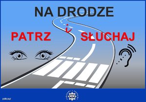 Zdjęcie przedstawiające plakat z napisem Na Drodze Patrz i Słuchaj, na tle ulicy z przejęciem dla pieszych, oczami i uchem