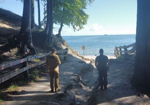 Zdjęcie przedstawiające wspólny patrol Policji i PSP na plaży.