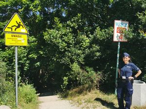 Zdjęcie przedstawiające policjantkę przy wejściu nr 4 na plażę znajdującą się na Oksywiu.