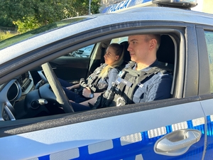 Zdjęcie przedstawia funkcjonariuszy w radiowozie